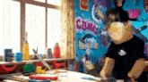 a cartoon character is standing in front of a wall with graffiti on it in a room .