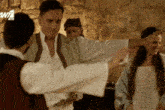 a group of people are dancing in front of a sign that says w7 on it