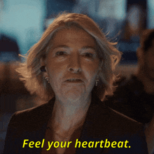a woman says " feel your heartbeat " in yellow text