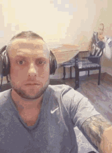 a man wearing headphones is taking a selfie