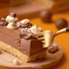 a piece of chocolate cake is being eaten with a fork and the words mr.cakes are visible in the background