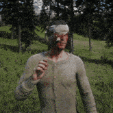 a man with a bandage on his head stands in a grassy field