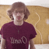 a man wearing glasses and a necklace is wearing a t-shirt that says ' wison ' on it