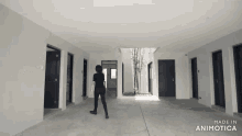 a woman standing in a hallway with the words made in animatica on the bottom right