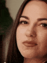 a close up of a woman 's face with a smile on her face