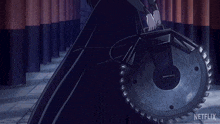 a woman in a black dress is holding a large circular saw and the word netflix is on the bottom of the image