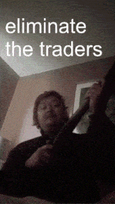 a man is laying on a bed with the words eliminate the traders below him