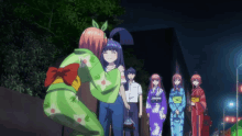 a girl in a green kimono hugs another girl