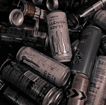 a pile of cans of energy drinks including black monster
