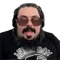 a man with a beard and sunglasses is wearing headphones and a black shirt .