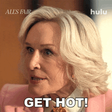 a woman in a pink suit has the words get hot written on her face