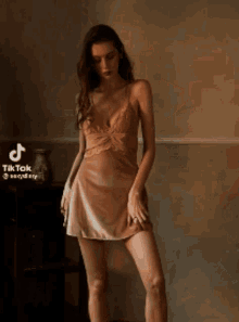 a woman is standing in a room with a tiktok watermark