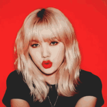a woman with blonde hair and red lips is wearing a black shirt and necklace