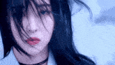 a close up of a woman 's face with her hair blowing in the wind and red lips .