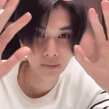 a close up of a person 's face with their hands on their face
