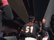 a man wearing a jersey that says chevrolet on the sleeve