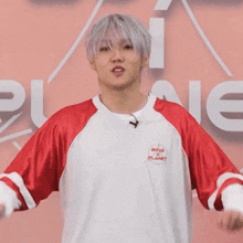 a young man wearing a red and white shirt that says boys on planet