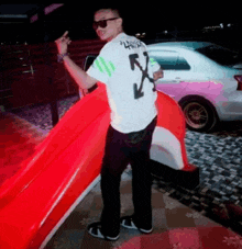 a man wearing sunglasses and a white shirt with the number 5 on the back