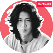 a black and white photo of a man with long hair and a starmaker sticker