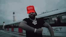 a man wearing a make america great again hat