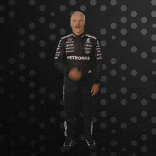 a man in a petronas racing suit is making a surprised face