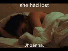 a woman laying on a bed with the words she had lost jhoanna above her
