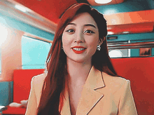 a woman with long red hair is wearing a yellow suit