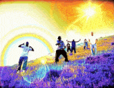 a group of people in a field with a rainbow in the background