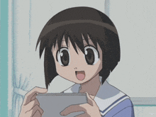 a person is holding a cell phone with a picture of a person 's face on it