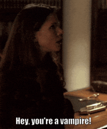 a woman says " hey you 're a vampire " in a dark room