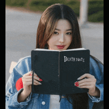 a girl is reading a death note book