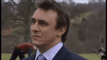 a man in a suit and tie is saying what did you say