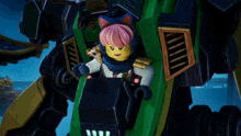 a lego figure with pink hair is sitting in a green vehicle