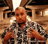 a man with a beard wearing a black and white shirt with a dollar sign on it