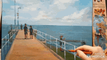 a painting of people walking along a pier is made in animatica