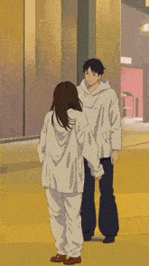 a man and a woman are standing next to each other and the letters n and e are flying in the air