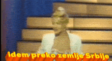 a blurred image of a woman with the words " idem preko zemlje srbije " in yellow
