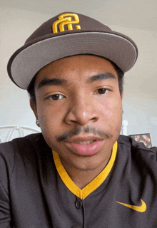 a man wearing a san diego padres hat