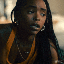 a close up of a woman 's face with the word netflix on the bottom right