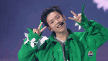 a young man wearing a green jacket and a pepsi logo