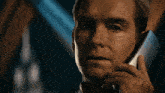 a man is talking on a cell phone with a surprised look on his face