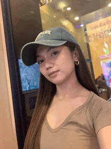 a woman wearing a hat that says ' abercrombie ' on it