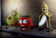a strawberry , a pear and a banana are standing next to each other on the sidewalk .
