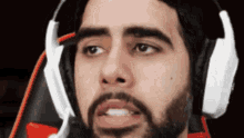 a man with a beard is wearing headphones and a microphone