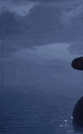 a gray robot with red eyes is standing in the water
