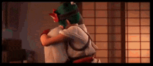 a man and a woman are hugging each other in a room with a window .