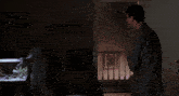 a man and a woman standing in a dark room with their mouths open