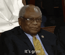a man in a suit and tie is saying " it 's grim "