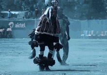 a person dancing in front of an airtel banner