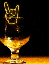 a woman is smiling in front of a martini glass with a neon sign that says i love you